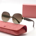 Sunglasses with quilted arm design on a pink case with a pink box in the background