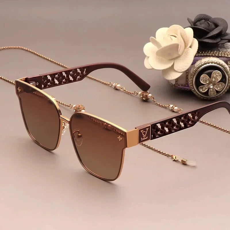 Luxury sunglasses with decorative chain on a neutral background