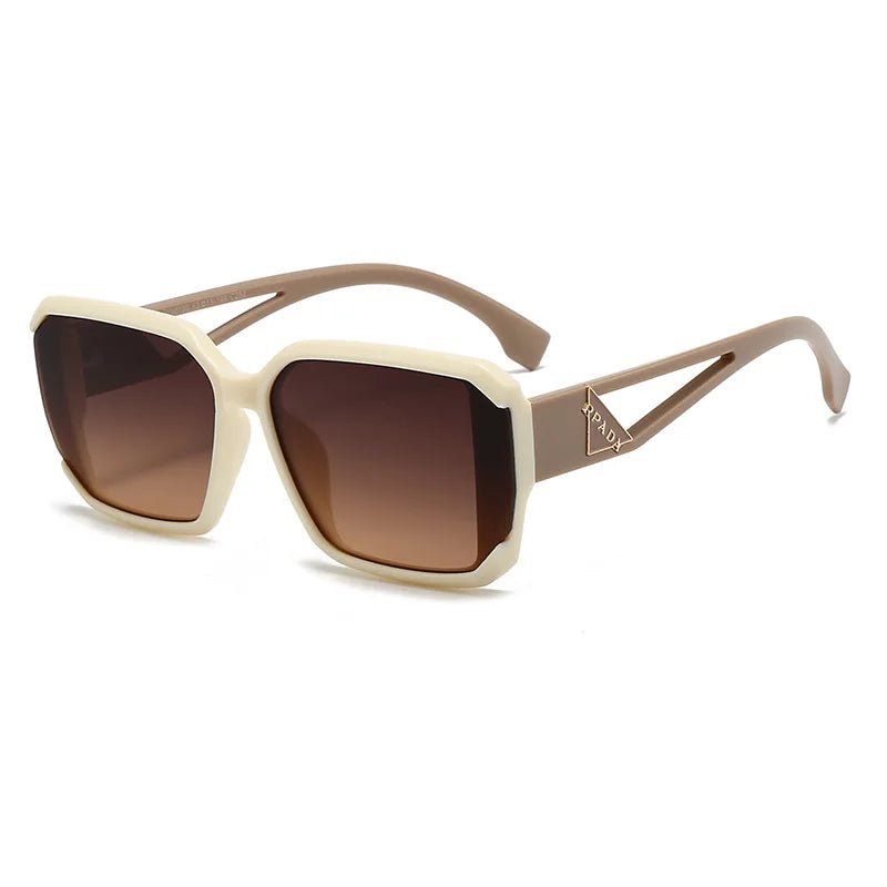 Sunglasses with beige frame and brown gradient lenses on a white background