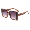 Brown sunglasses with a gradient lens on a white background