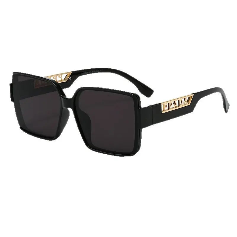 Sunglasses with gold frame and brown gradient lenses on a white background