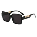 Black sunglasses with gold accents on a white background