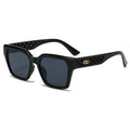 Black sunglasses with intricate design on a white background