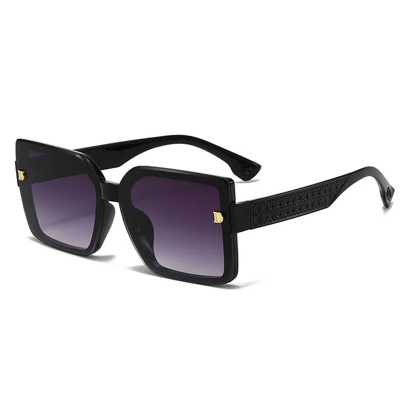 Black sunglasses with gold accents on a white background