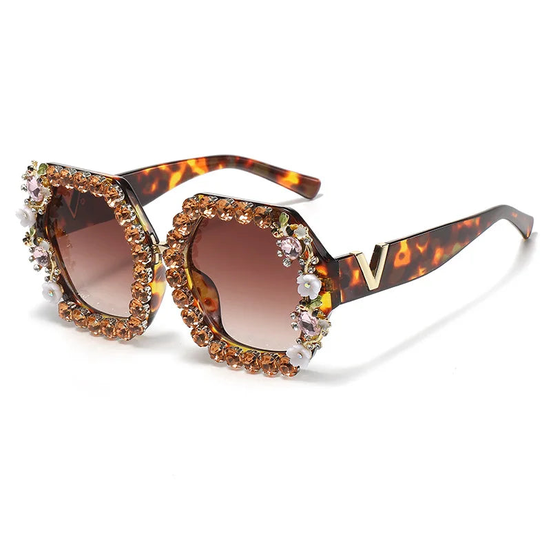 Sunglasses with tortoiseshell frame and brown lenses on a white background
