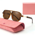 Tortoiseshell sunglasses with brown lenses on a pink case against a white background