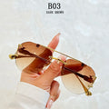 Sunglasses with gold frame and dark brown lenses held by a hand against a light background