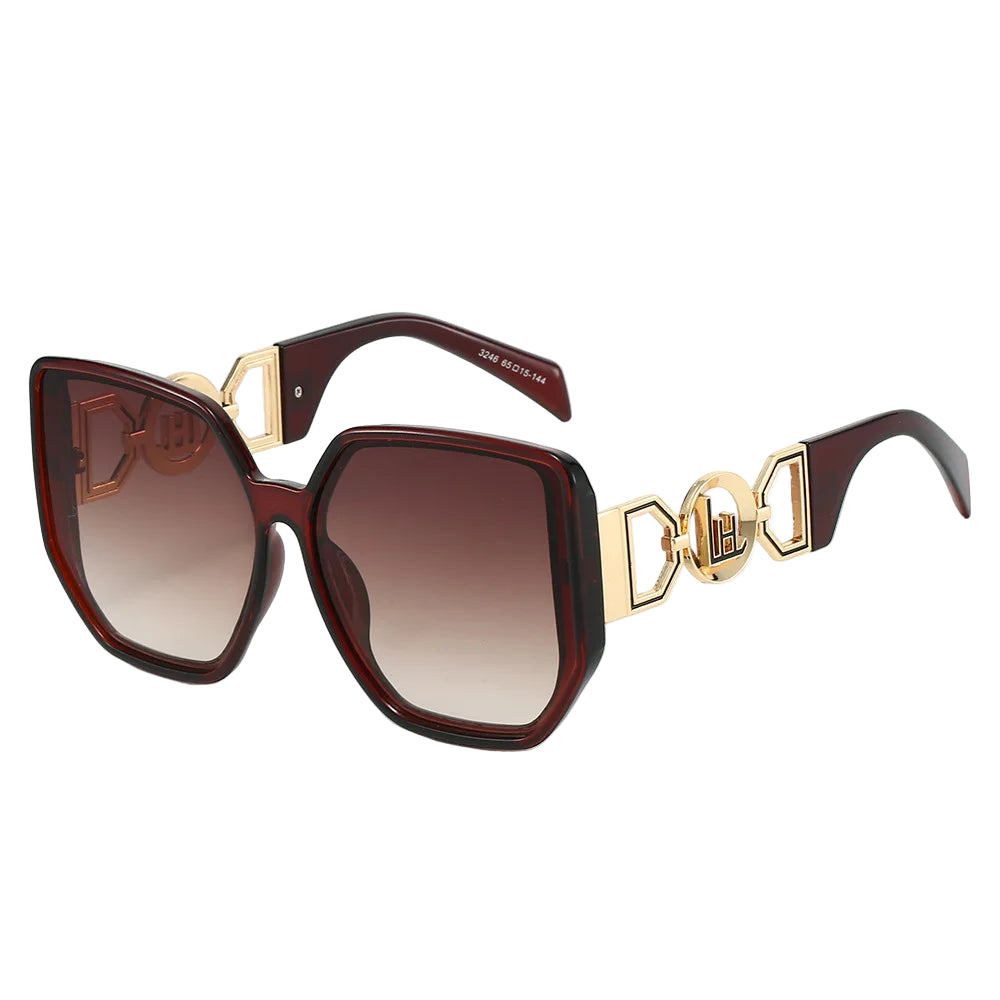 Sunglasses with gold accents and brown gradient lenses on a white background