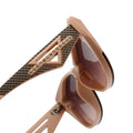 Close-up of a pair of sunglasses with a decorative frame on a white background