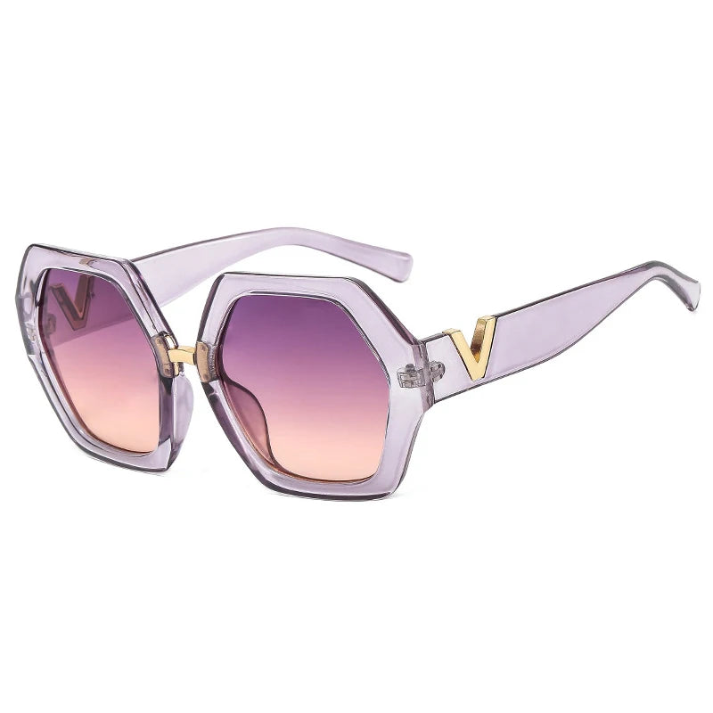 Sunglasses with a clear frame and pink gradient lenses on a white background