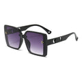 Black sunglasses with purple gradient lenses on a white background