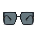 Black sunglasses with gold accents on a white background