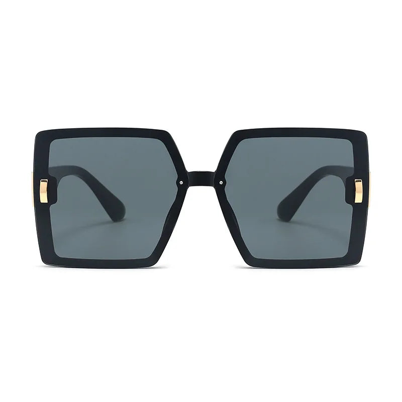Black sunglasses with gold accents on a white background