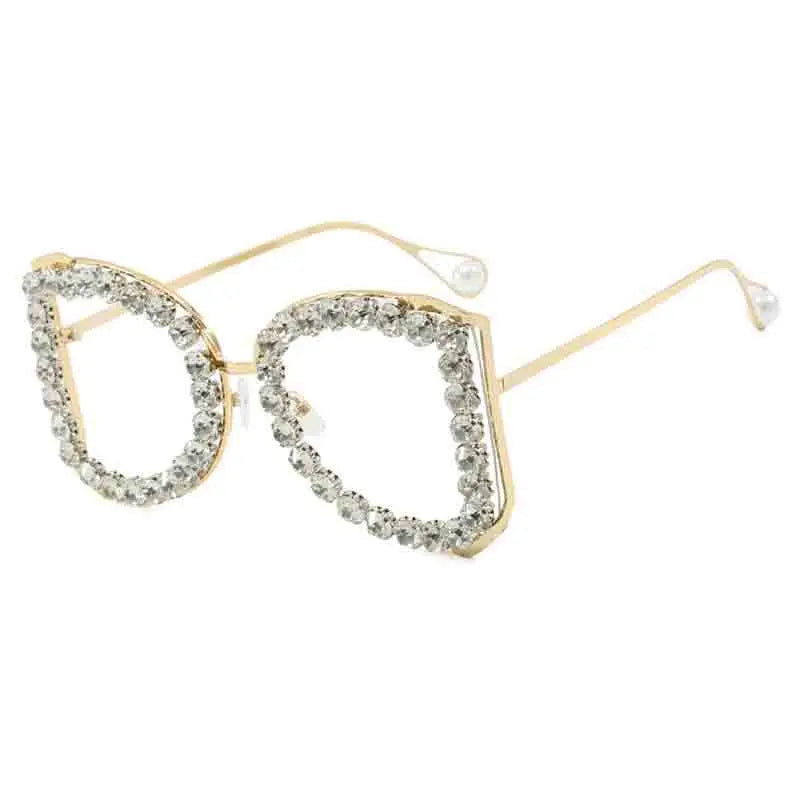 Gold-framed sunglasses with crystal embellishments on a white background
