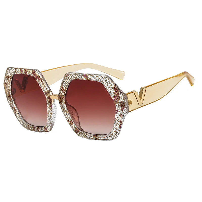Sunglasses with gold frame and brown gradient lenses on a white background