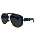 Black sunglasses with a metallic frame on a textured surface, branded 'seventpeople'.