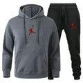 Gray hoodie and black jogger pants set with red logo on a white background