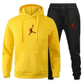 Yellow hoodie and black pants with red logo on a white background