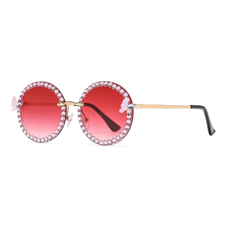 Sunglasses with red lenses and decorative frame on a white background