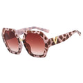 Sunglasses with leopard print frame and brown gradient lenses on a white background