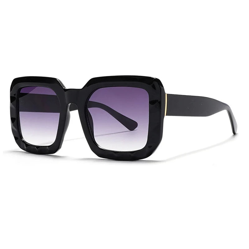 Sunglasses with a gradient pink to brown frame on a white background