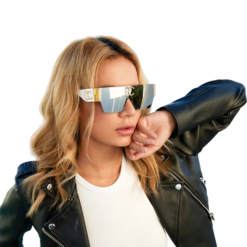 Woman wearing reflective sunglasses and a black leather jacket on a white background