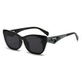 Black sunglasses with carbon fiber arm design on a white background