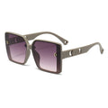 Sunglasses with a gradient purple lens and beige frame on a white background