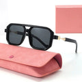 Black sunglasses with a pink case on a white background