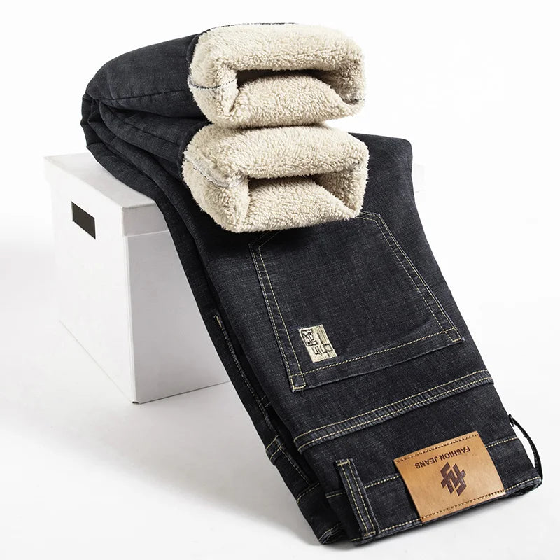 Black denim jeans with beige sherpa lining on a white stool