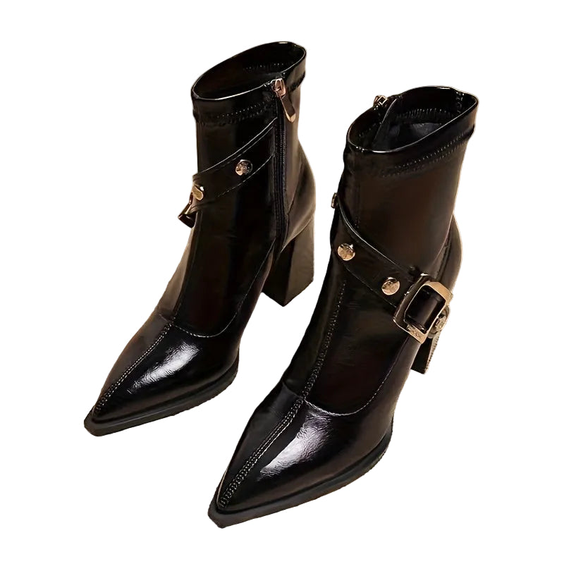 Pair of black leather boots with buckles on a white background