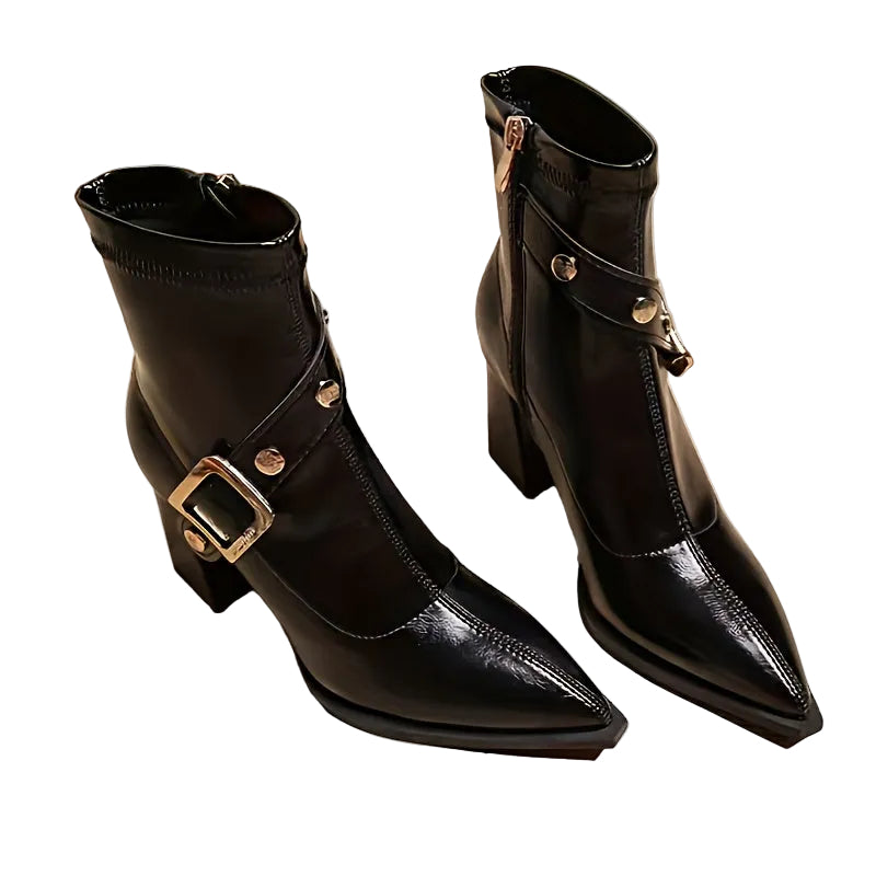 Black leather boots with gold buckles on a white background