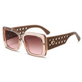 Sunglasses with brown gradient lenses and decorative frame on a white background
