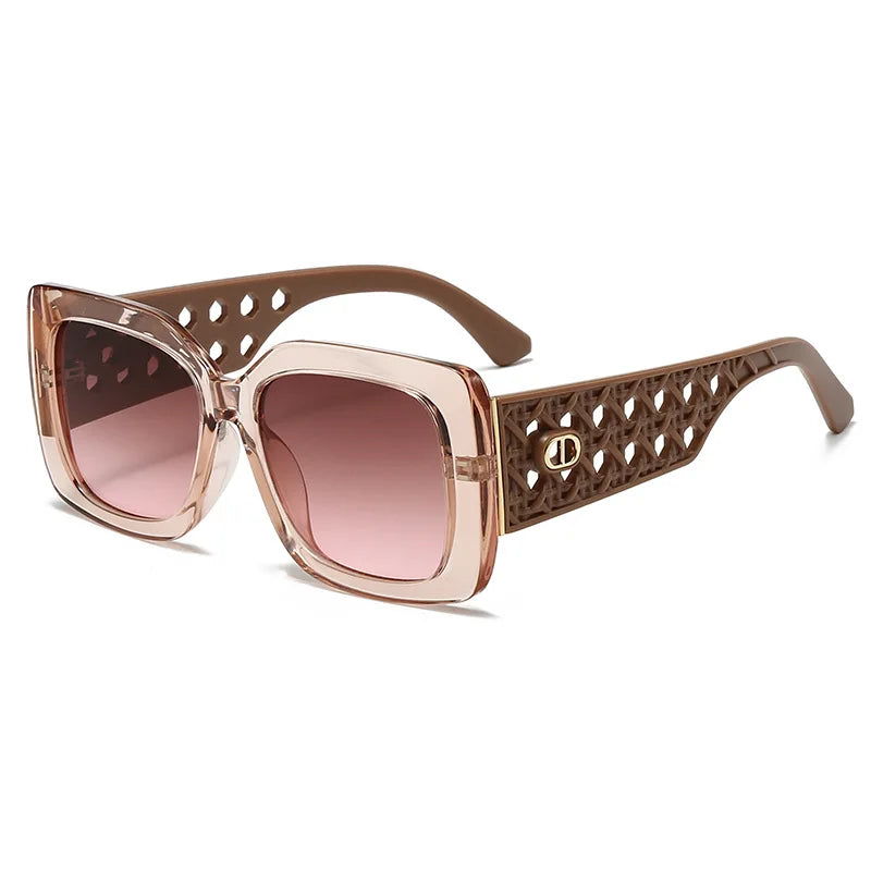 Sunglasses with brown gradient lenses and decorative frame on a white background