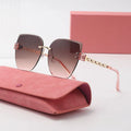 Pink sunglasses with gold accents on a pink case against a white background