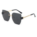 Sunglasses with black lenses and gold frames on a white background
