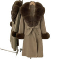 Brown coat with fur trim on a hanger against a white wall