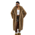 Person wearing a long brown fur coat on a white background