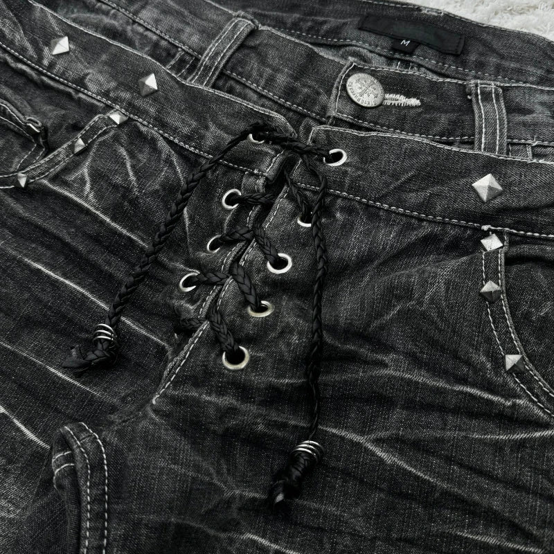 Black denim shorts with studded details and lace-up front.